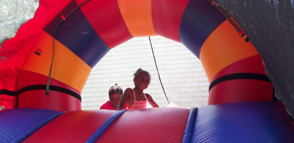 Young attendees at a previous Summer Jam enjoy the free moon bounce and slide, a returning attraction at this year’s event.