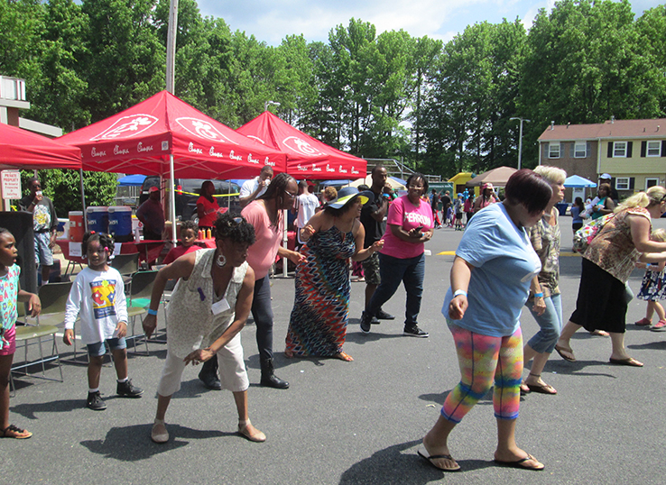 HDGHA residents and attendees of Summer Jam learn line dances during the event.