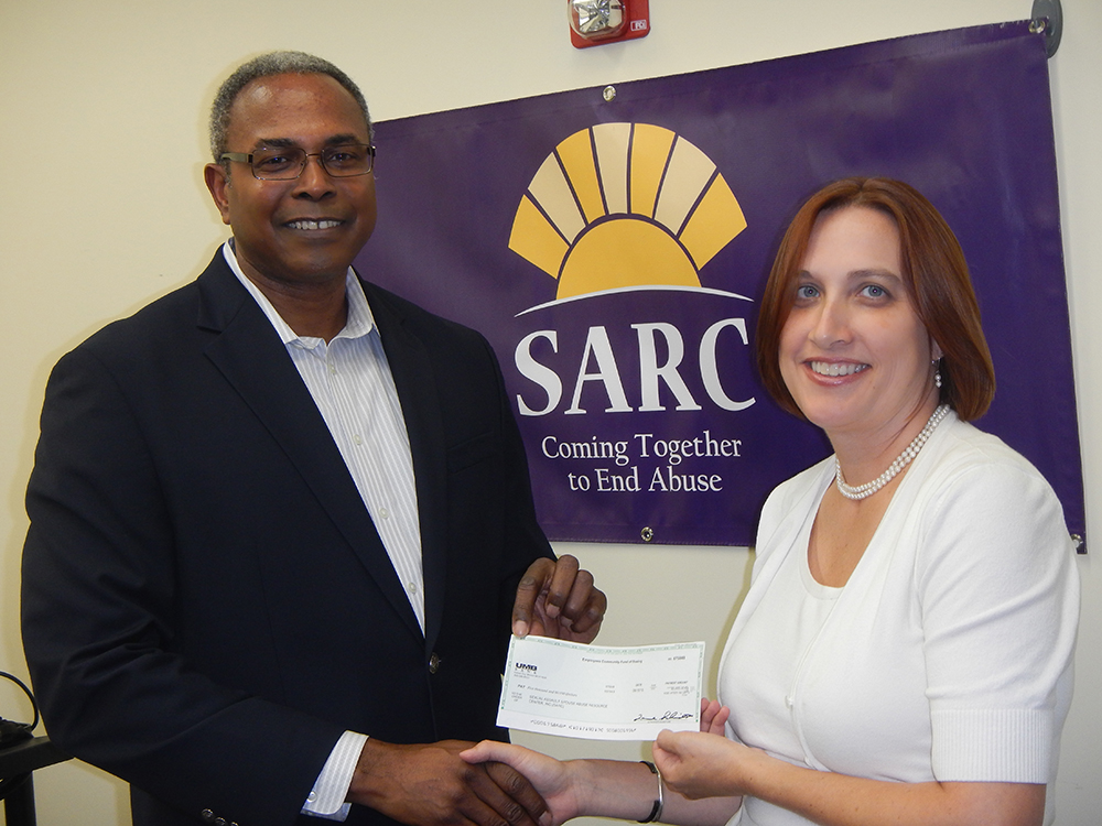 Boeing’s Employees Community Fund Board Member David Lockhart, (left) presents SARC’s Director of Legal Services, Gwendolyn Tate, Esq.  with a check for $5,000 to support the work of the SARC legal department on behalf of victims of domestic violence in the community.