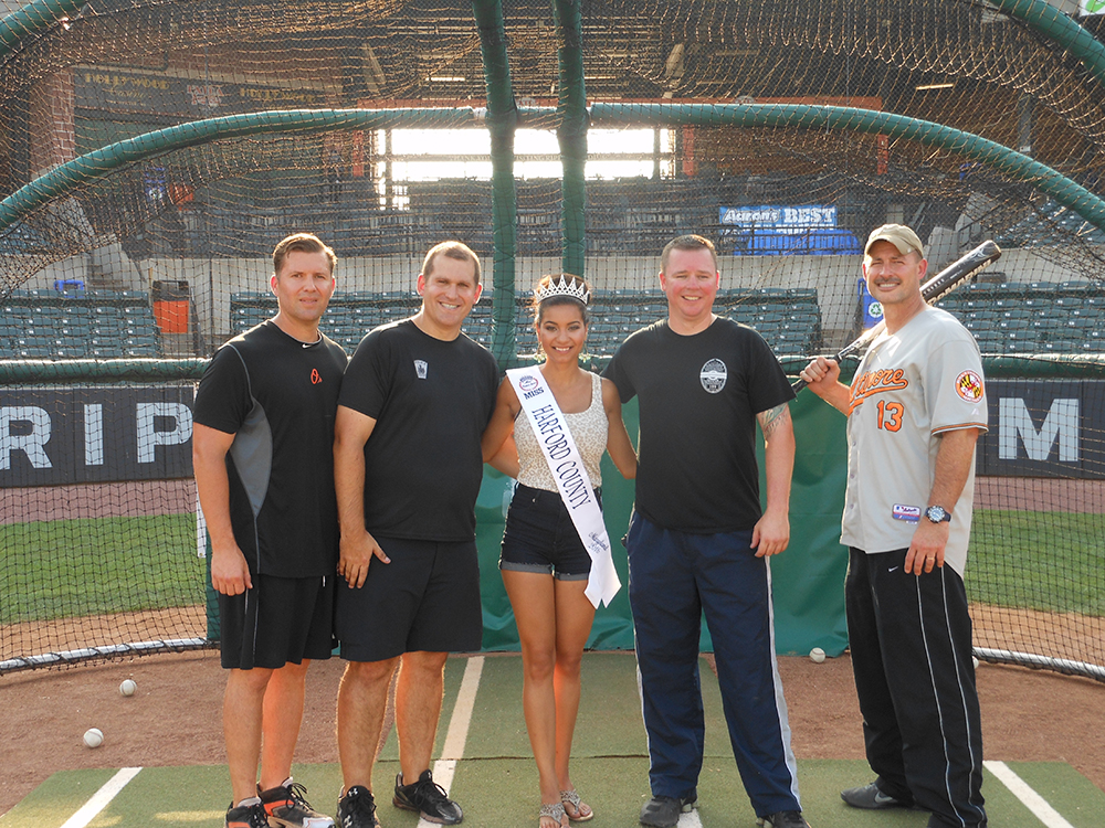 Members of the Aberdeen Police Department, who earned 1,155 points to win the Officer’s Cup at this year’s Home Runs for the Homeless, pose with Miss Harford County, Allison Redman. Left to right: Will Reiber, Rob Tice, Miss Harford County, Allison Redman, Paul Forsmark and Bill Garrett.
