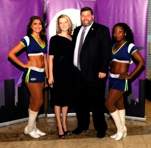 Harford County Director of Housing and Community Development Len Parrish and his wife Andrea pose with Bay Hawks’ cheerleaders at the Harford Family House Bird’s Ball on August 29. The charity event raised $64,000 to help the homeless of Harford County.