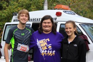 Top finishers and siblings Russell and Lydia Davis flank Holly, the namesake of the Holly’s Hope 5K. 