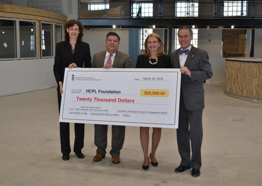 Lyle E. Sheldon, president/CEO of University of Maryland Upper Chesapeake Health (right) and Ken Ferrara, vice president and executive director of The Upper Chesapeake Health Foundation, present a check for sponsorship of the Business Center at the new Havre de Grace Library to Mary Hastler, CEO of Harford County Public Library (second from right), and Rebecca Jessop, foundation director of Harford County Public Library. (Photo by Sarah Karantonis/The Upper Chesapeake Health Foundation)
