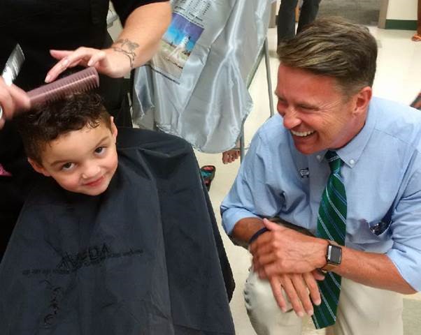 Four-year-old Jordan Schulze getting a haircut for pre-school with encouragement from Harford County Executive Barry Glassman