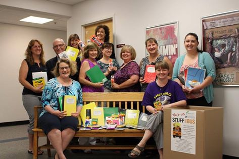 Staff of the Harford County Public Library (HCPL) pose by a collection bin for the GEEF “Stuff the Bus” collection for school supplies. Items are being collected at all HCPL branches and will be distributed to financially disadvantaged students in Harford County.