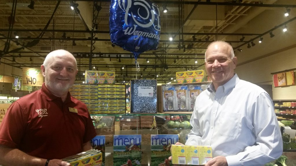 Wegmans Supports GEEF Stuff the Bus Campaign: Al Jackson (left), manager of the Abingdon Wegmans Food Market, and Warren Hamilton, GEEF Board Chair, display some of the $2,000 worth of school supplies donated by Wegmans to support GEEF's “Stuff the Bus” campaign. Donated items will be distributed to financially disadvantaged students in Harford County. 