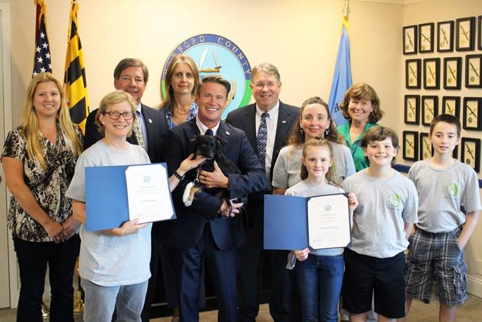 Pictured from left, front row: Linda Andrews; County Executive Barry Glassman with Linda’s dog, Toby; Dr. Danielle Orlando-Kepner and her children Gianna, Kiegan, and Tristen Back row from left: Harford County government officials Laura Coste, Watershed Protection and Restoration Office; Joseph J. Siemek, director of Public Works; Christine Buckley, Watershed Protection and Restoration Office; Scott Kearby, deputy director of Public Works, and Kriste Garman, Parks & Rec