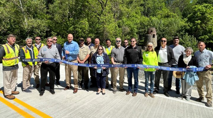 Harford County Executive Bob Cassilly, center left, joins Director of Public Works Joe Siemek, left of County Executive, and others to cut the ribbon during the official road reopening ribbon cutting ceremony for the new bridge on May 25, 2023.