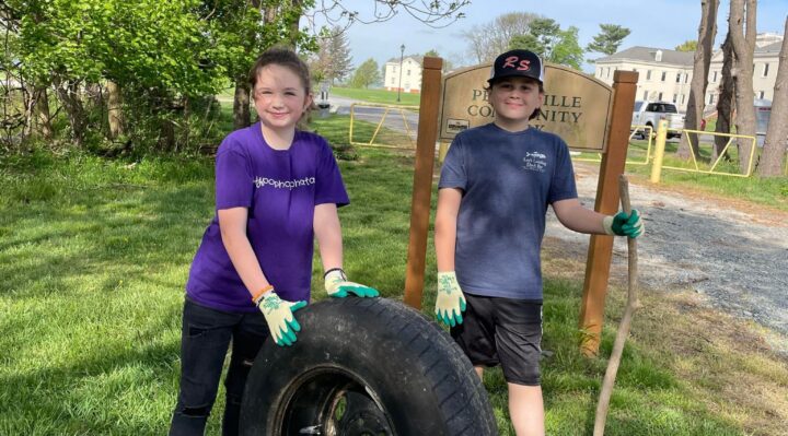 River Sweep volunteers Alonna Kunkel and Brandon Webb, participating with the Conowingo Elementary School’s Environmental Club and Green Team, retrieve a tire from the shoreline at Perryville Community Park during the 2023 cleanup. (Photo Courtesy of Holly Kunkel) 