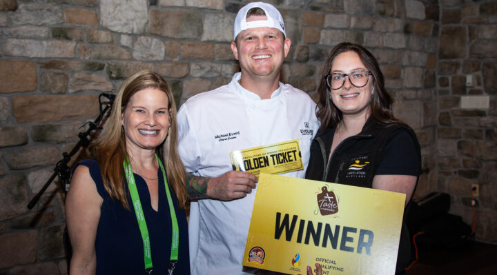 Amber Shrodes, director of philanthropy and community engagement for Harford County Public Library, and Cori R. Grafer, events and engagement manager for the Restaurant Association of Maryland, present the Seafood Golden Ticket to Chef Mike Everd, chef de cuisine at The Local, at Taste of Harford on May 19 at Vignon Manor Farm. (Photo by Ujen Jonchhe)
